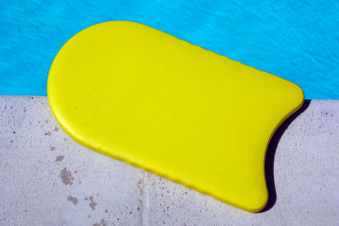 A kickboard lying at the poolside