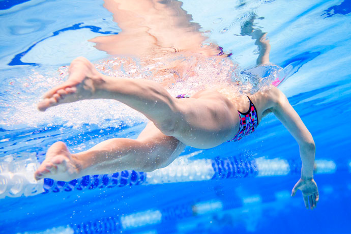Underwater shot focused on the flutter kick of a front crawl swimmer