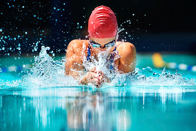 A young man swimming breaststroke