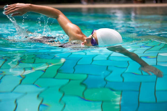 A young woman swimming the freestyle stroke
