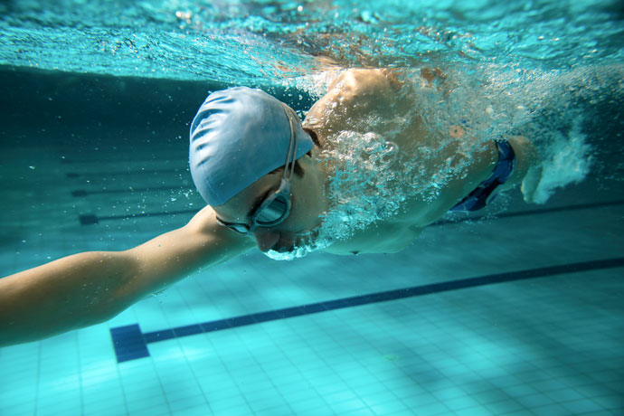 Close-up of a front crawl swimmer exhaling underwater