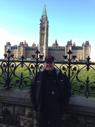 Waiting for my bus after a day working. Chilly in Ottawa , but not with my Carhartt Overall Bib. By the way, my bus stop in in front of the Parliament