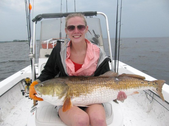 Michelle Dubiel of Fountain Inn, S.C., with the biggest fish she's ever caught; a giant red drum caught on North Carolina's Neuse River.