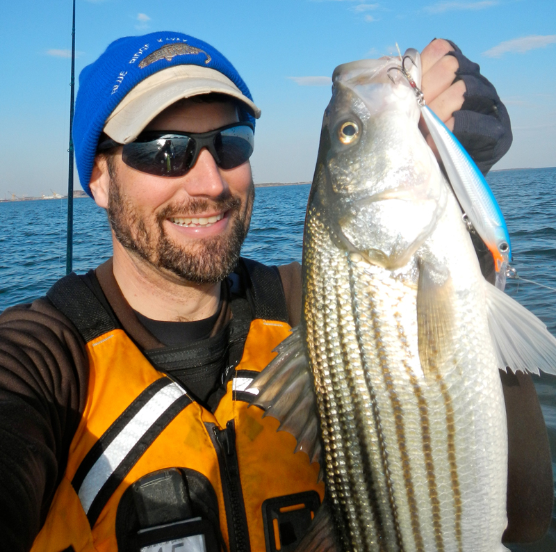 Stubbornness invites skunk stripes, while adaptation overcomes. Jeff Little with a jerkbait striper caught on the troll. 
