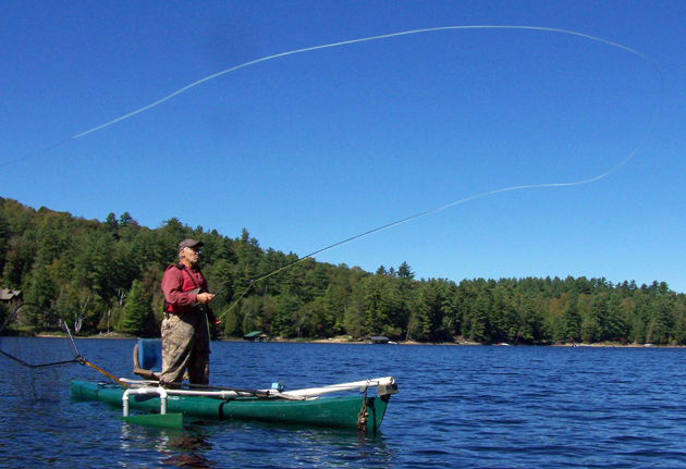 Small slings his wares while atop a late model Old Town tandem kayak. 