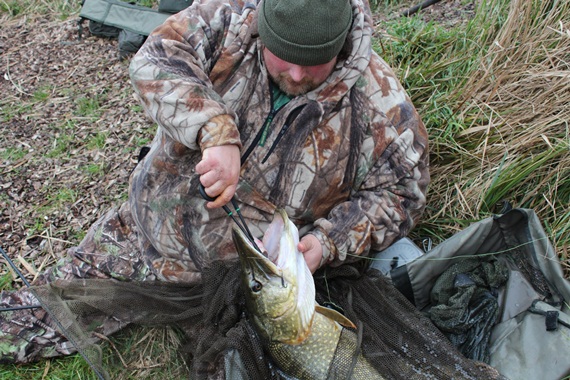 Mark Barrett unhooking large pike