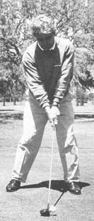Close-up black-and-white photo of golfing stance
