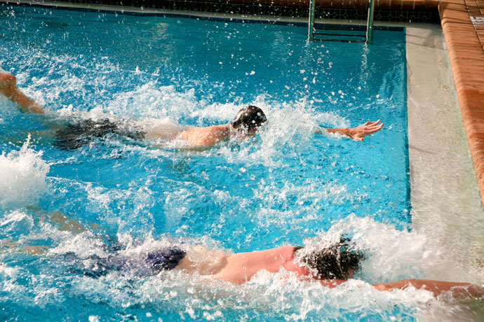 Two men engaged in a front crawl race