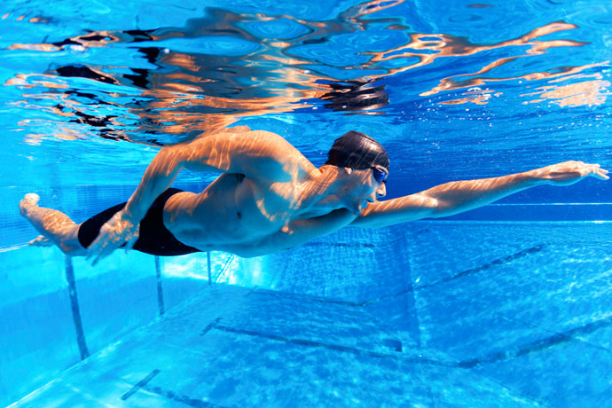 A freestyle swimmer floating in the water
